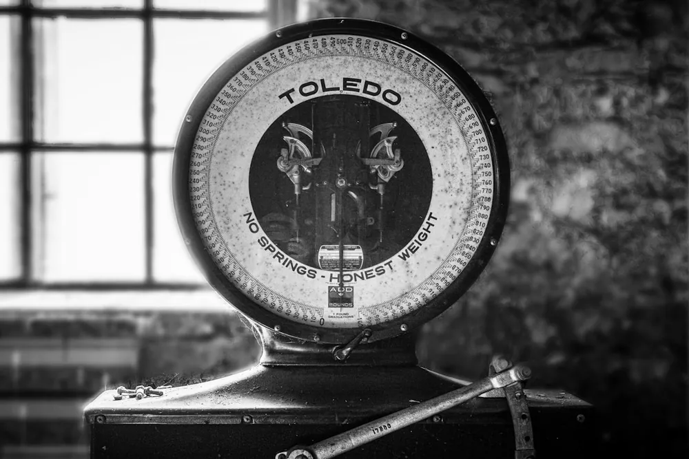 A vintage Toledo scale reading 'No Springs, Honest Weight'