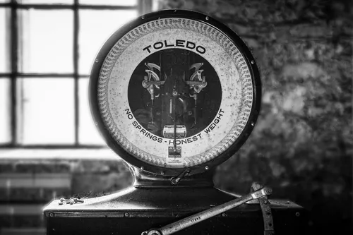 A vintage Toledo scale reading 'No Springs, Honest Weight'