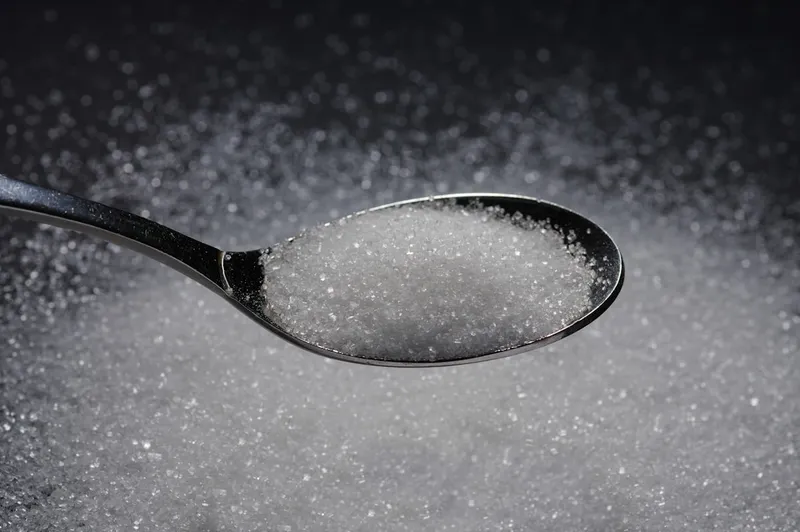 A spoon heaped with sugar